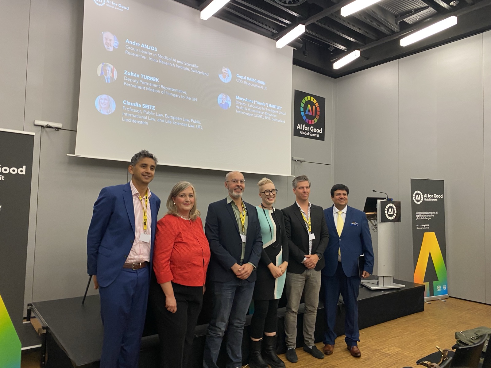The panel speakers gathered in front of the stage at the AI for Good Summit