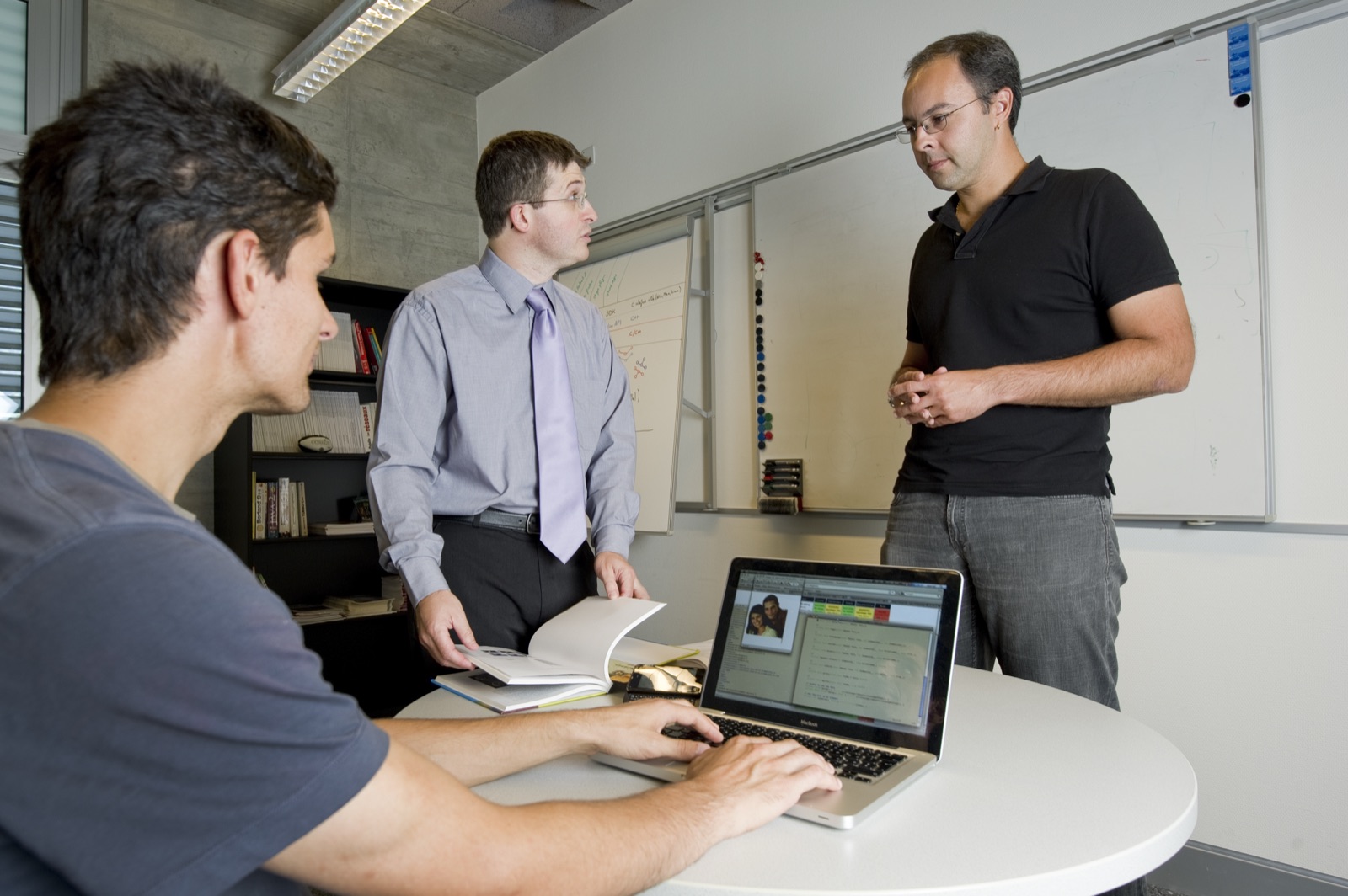 Discussion around a laptop in a Idiap meeting room