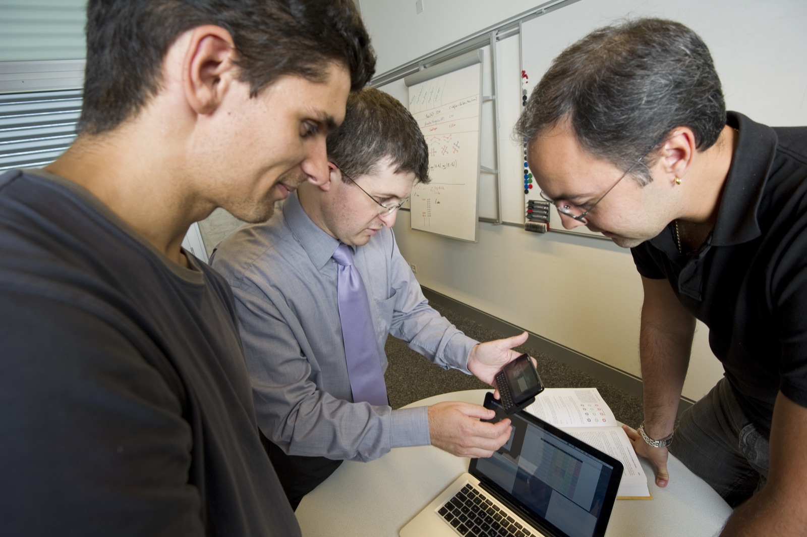 Examining results on a phone and a laptop at Idiap