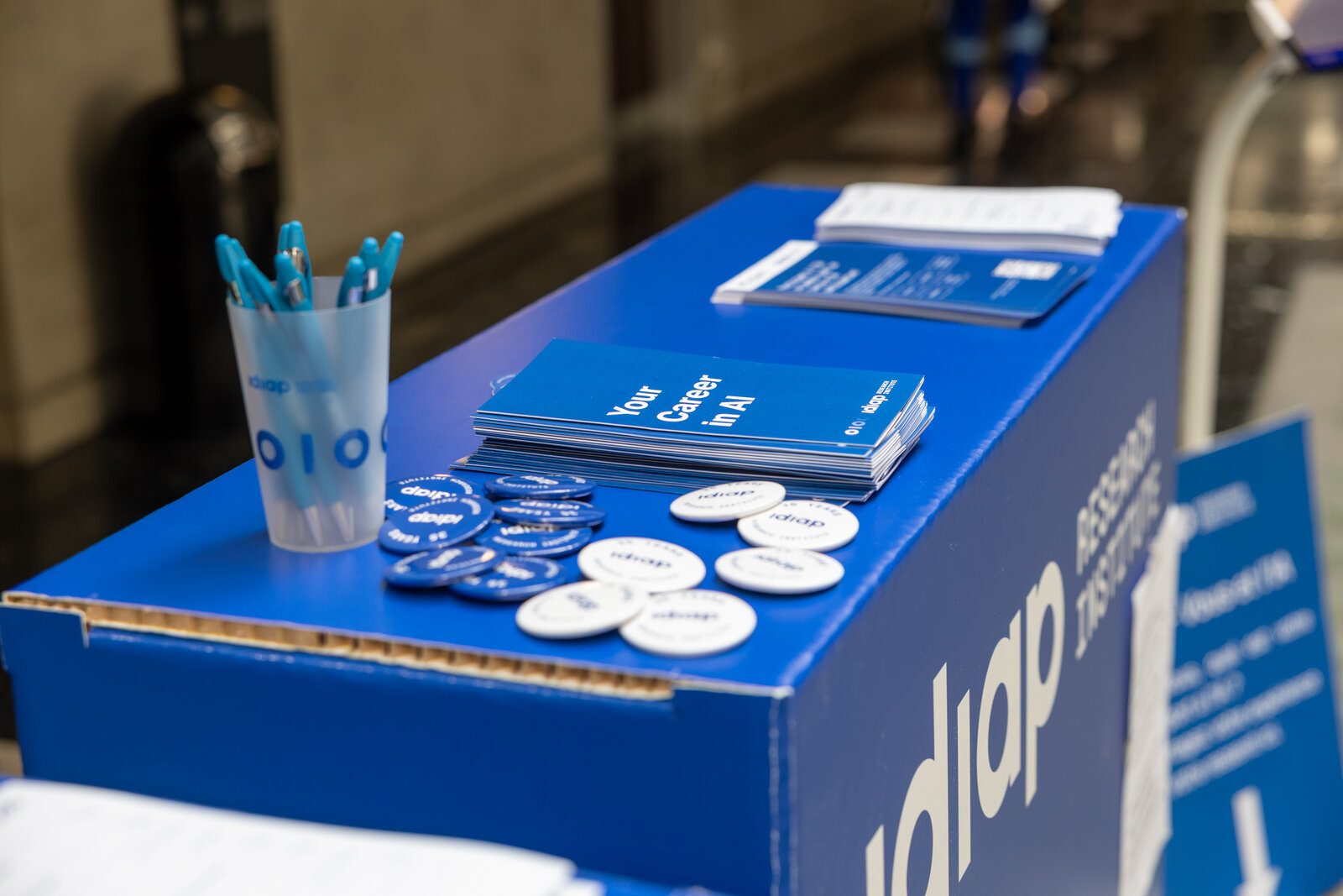 Idiap brochures, badges and pens at the Open Day