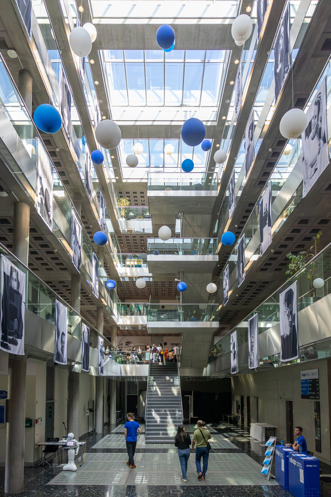 The Idiap atrium decorated with blue and white balloons