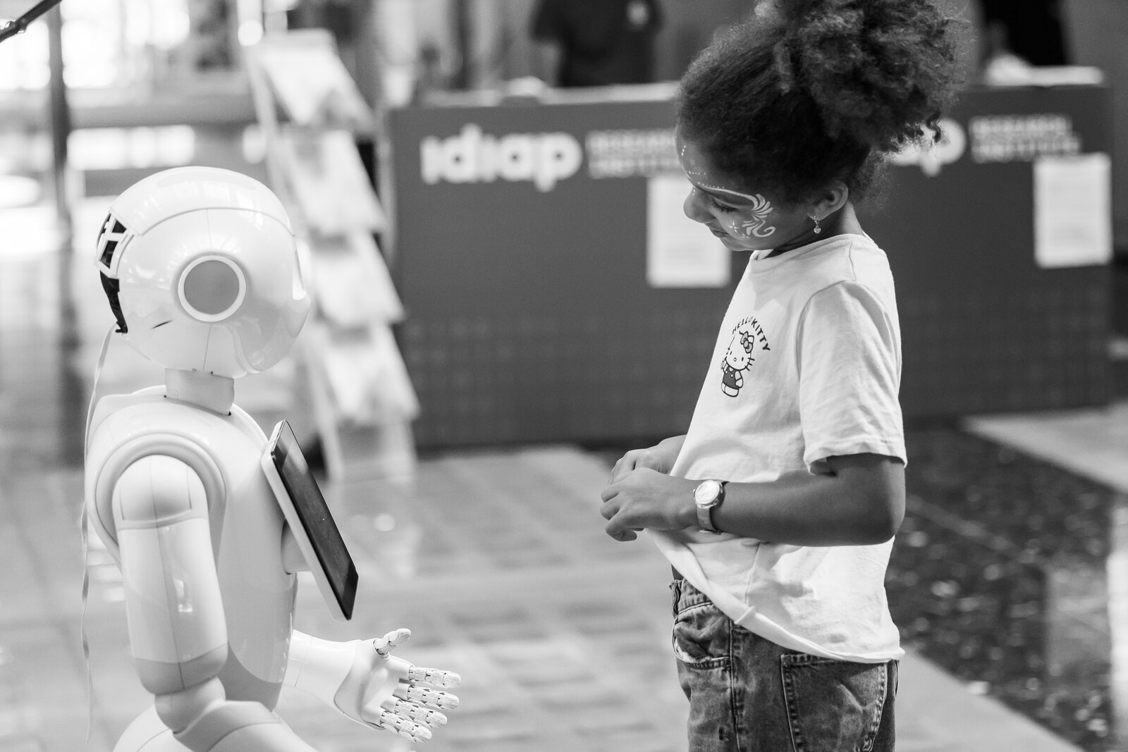 A child interacting with a humanoid robot