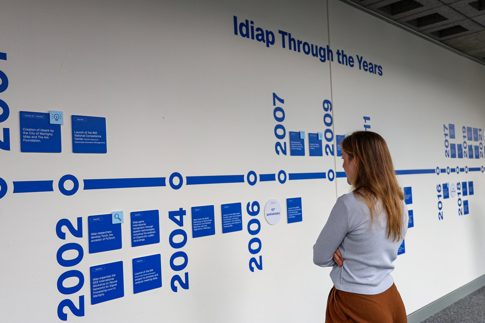 A visitor looking at the Idiap history timeline